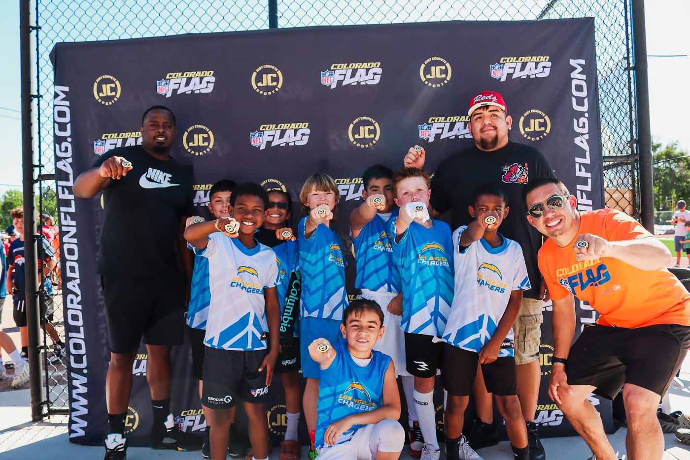 Flag football team in blue at the photo backdrop