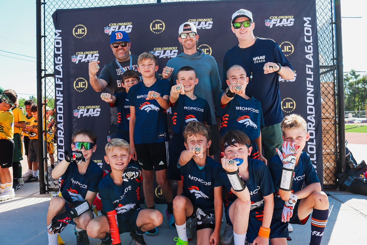 Team and coach at the Colorado NFL FLAG backdrop